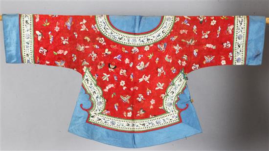 A Chinese embroidered silk red brocade jacket, late Qing dynasty,